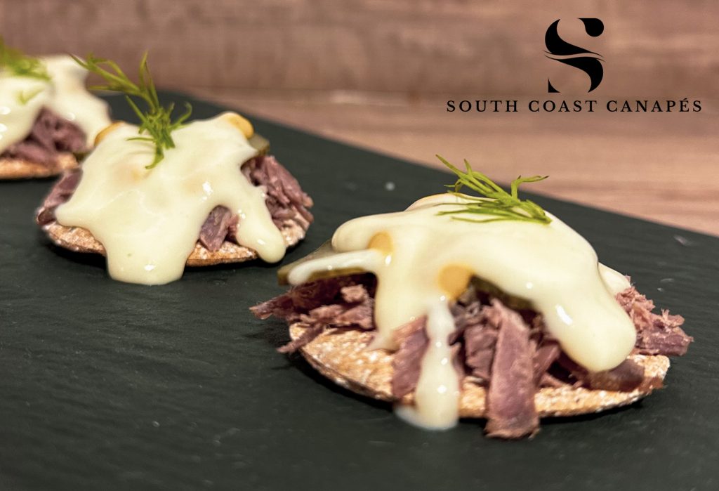 Salt beef, gherkin and cheese sauce on sourdough cracker